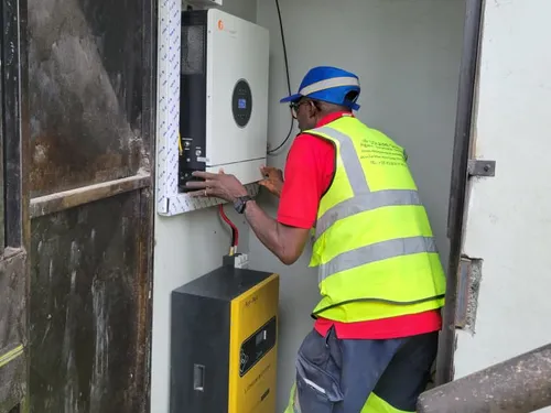 Technician installing an inverter and a lithium battery